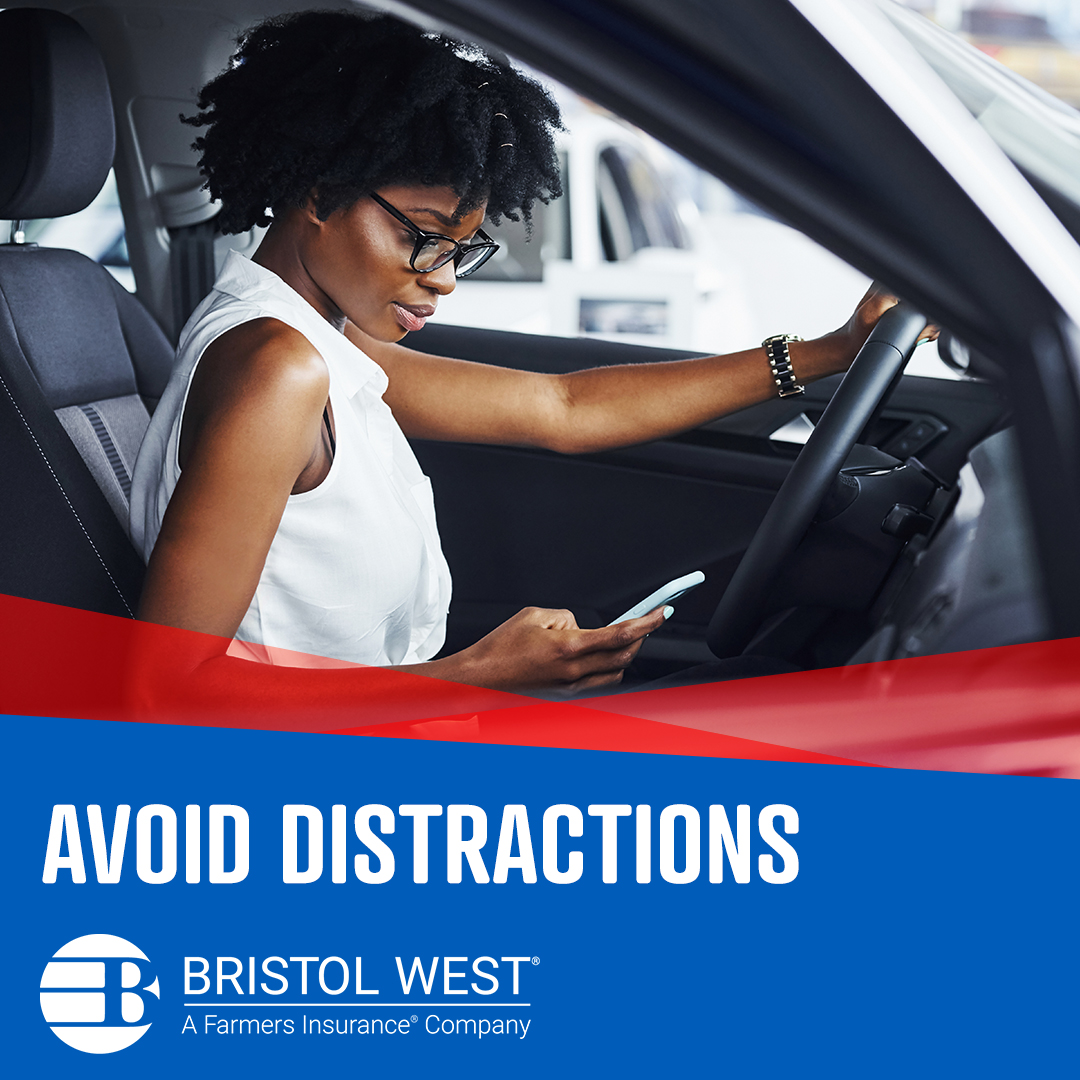 Woman driving with one hand on the wheel while looking down at cellphone