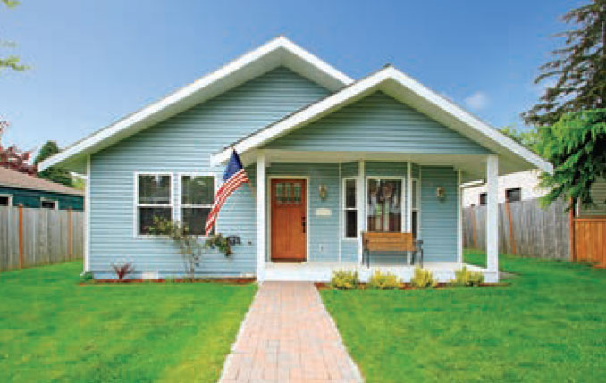 Stock photo of a house with green lawn